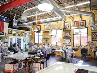 Tattoo artists work at Arsenal Tattoo & Design