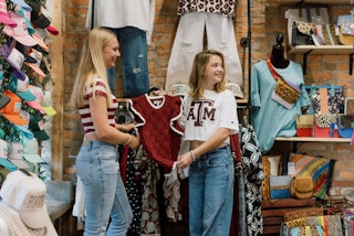Two girls looking at Texas A&M Gameday gear at Texas Rose Boutique in Bryan, Texas