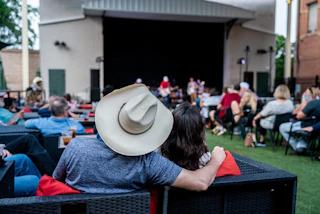 Couple watching Troubadour Pre-Party at The Palace Theater in Historic Downtown Bryan, TX