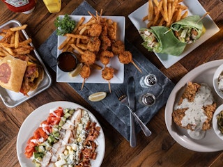 Spread of food dishes at Billys Grille Bar in Bryan TX