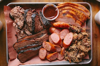 a platter of different bbq meats at All the Kings Men in Bryan, Texas